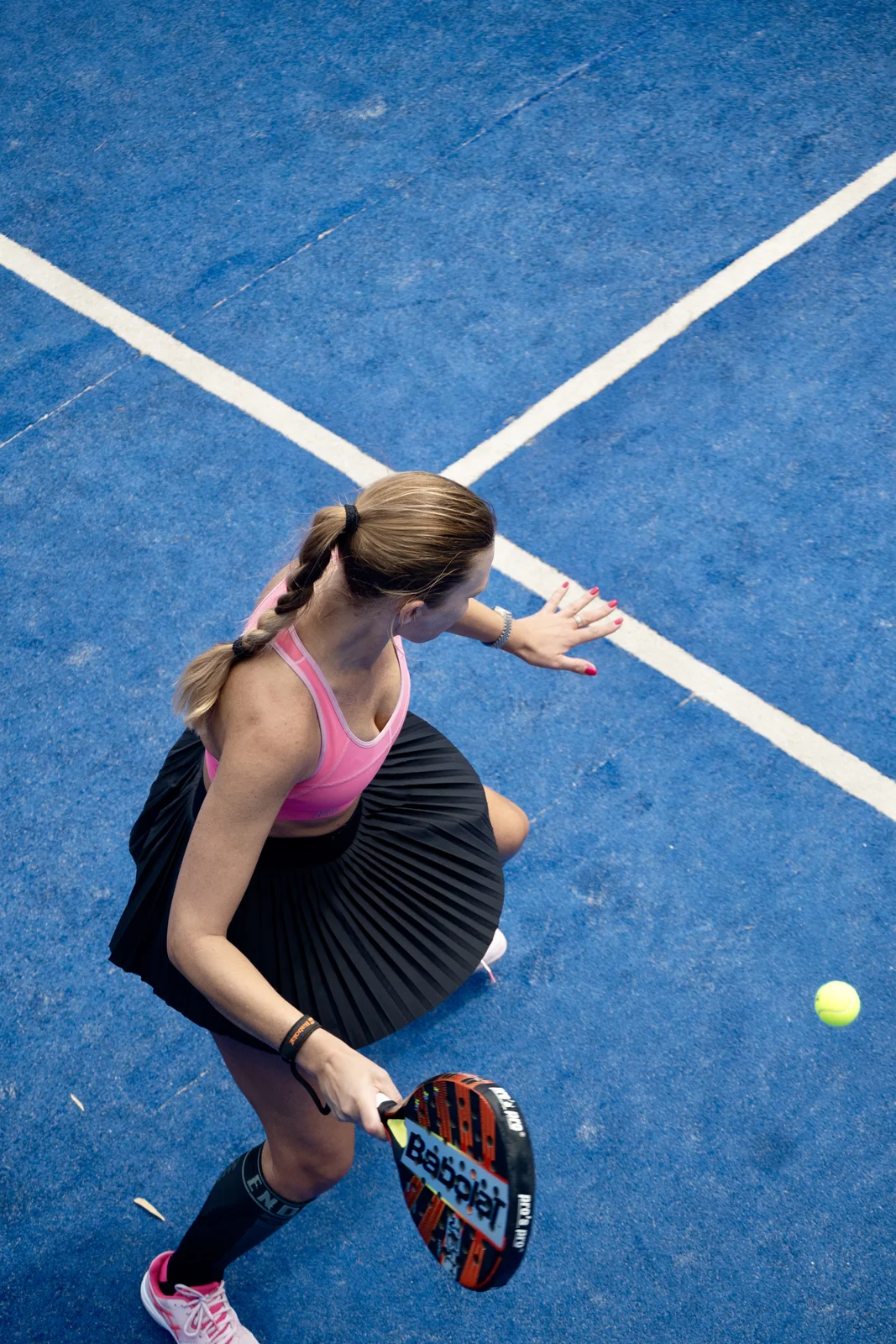Player seen from above about to hit