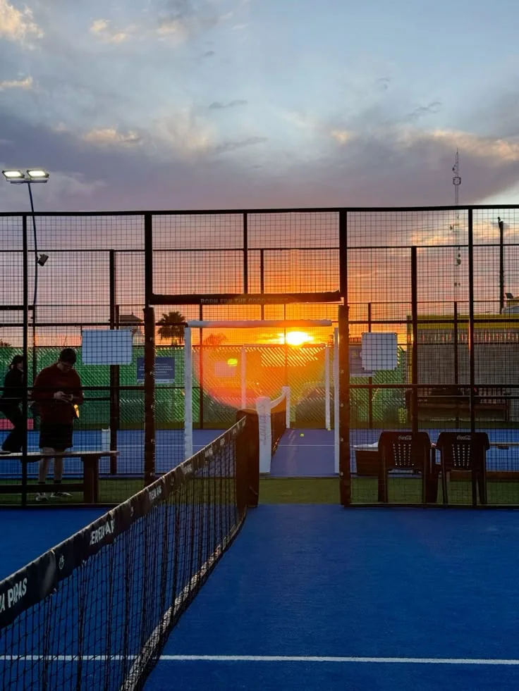 Sunset through the net of a padel court