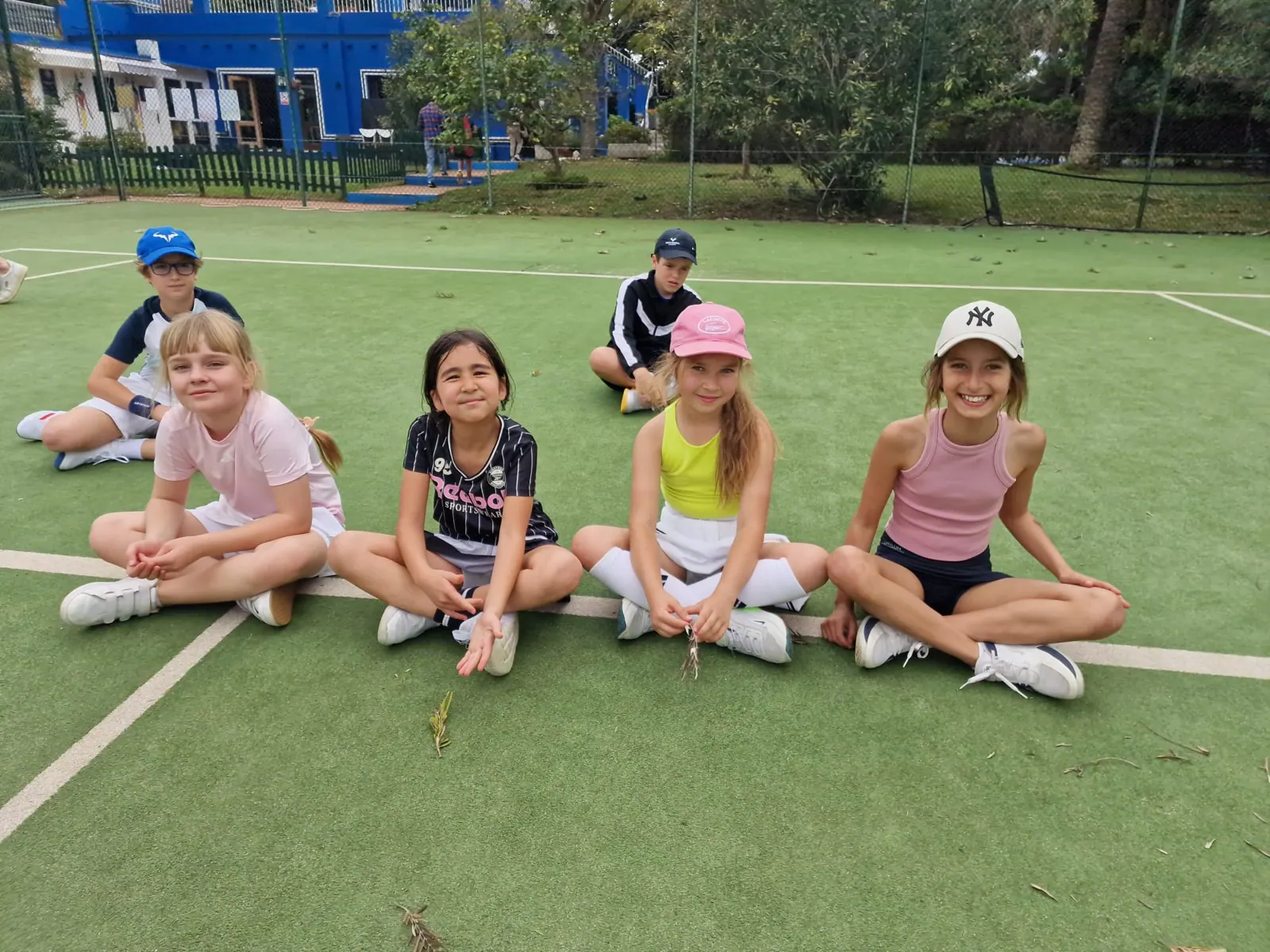 Students sitting on court during the tournament