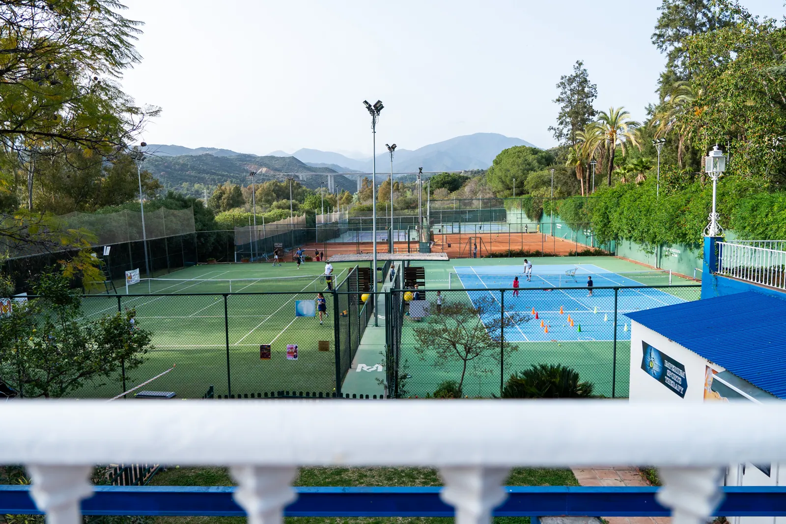 View of the club tennis courts with the mountains behind